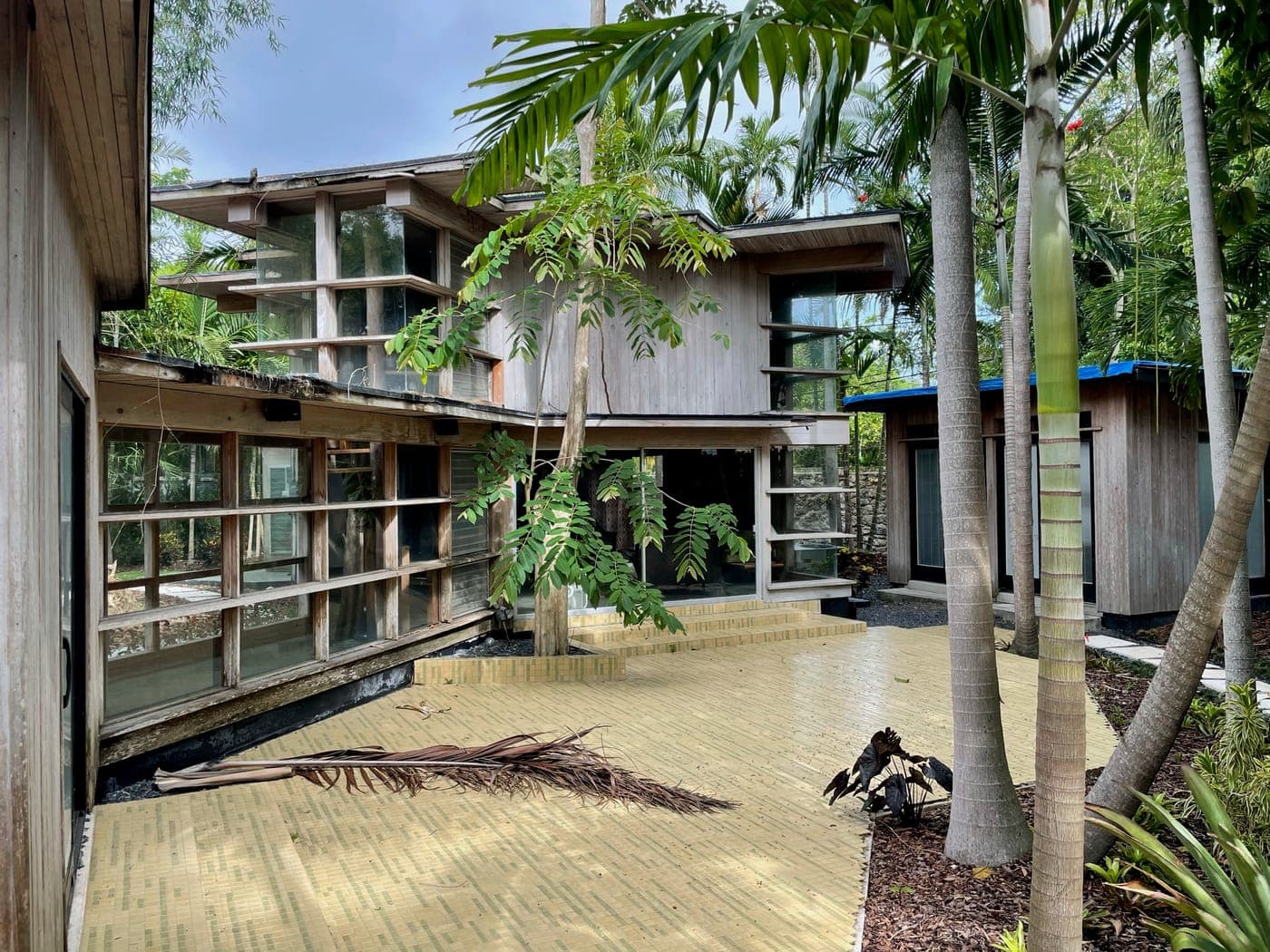 Alfred Browning Parker tropical modernist home. The glazed living pavilion seen from the garden at dusk.