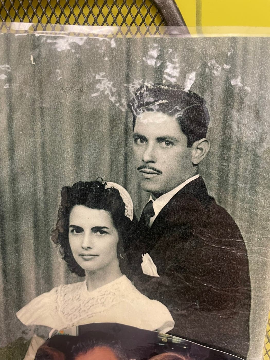 A studio portrait of a couple, photographed from the print.